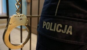 kajdanki, kraty i napis Policja
